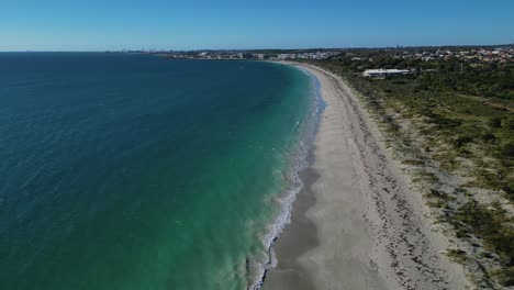Aerial-drone-tilt-up-shot-over-empty-coogee-beach-in-Perth,-Western-Australia-on-a-bright-sunny-day