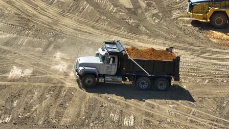 A-dump-truck-full-of-dirt-backing-up