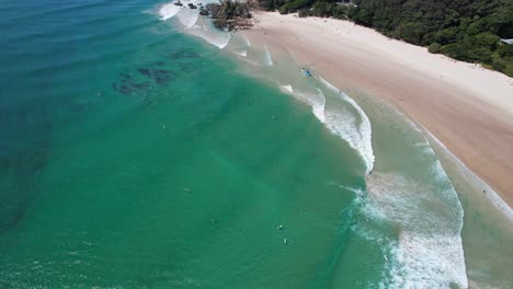 Ocean-Waves-Splashing-On-Sandy-Shore-Of-Clarkes-Beach-In-New-South-Wales,-Australia---aerial-shot