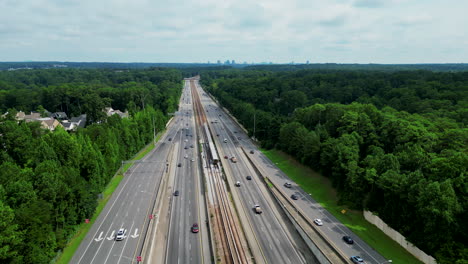 Aerial-panoramic-view-of-wide-transport-corridor-in-wooded-flat-landscape-in-suburbs
