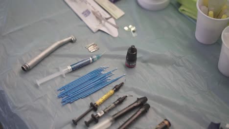 In-a-medical-brigade-in-a-poor-community,-several-dental-medical-instruments-prepared-on-a-table