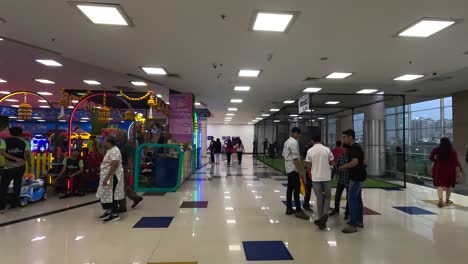POV-shoot,-people-are-bringing-their-little-kids-on-holiday-to-have-fun-in-the-game-zone-at-the-super-mall