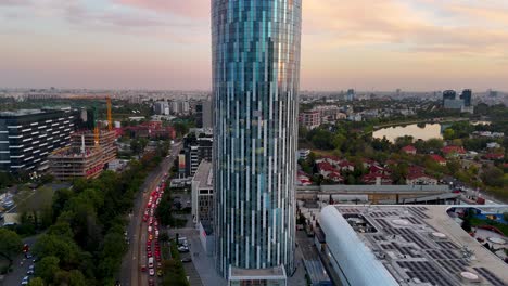 Slow-Cinematic-Reveal-Of-Bucharest-Business-District-at-Sunset---A-Bird's-Eye-View