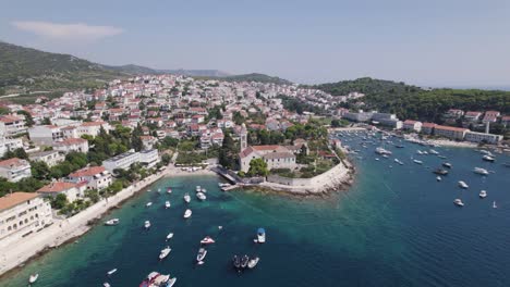 Beautiful-bay-filled-with-boats,-city-of-Hvar-in-background