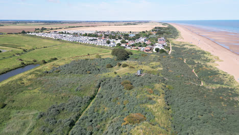 Above-the-shoreline,-video-footage-captures-the-serenity-of-Anderby-Creek,-a-quiet-and-unspoiled-beach-in-the-town-of-Anderby-on-the-Lincolnshire-coast
