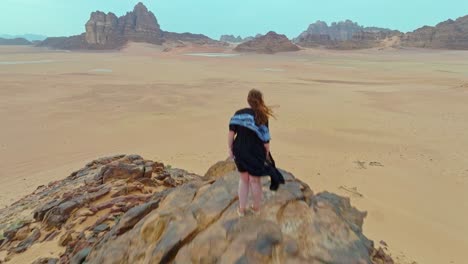 Aerial-View-of-Wadi-Rum-with-a-Woman-Standing-in-the-Desert