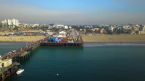 Aerial-view-toward-the-Pacific-park-on-the-Santa-Monica-pier,-in-Los-Angeles,-USA