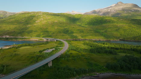Vibrant-green-mountains-behind-Austerstraumen-and-Vesterstraumen-bridges-along-Lofoten-E10-highway,-Norway