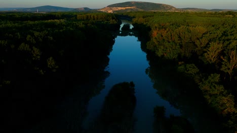 Calm-River-And-Forested-Landscape-In-Lower-Austria---aerial-shot