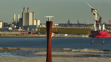 Aerial-orbit-around-maritime-radar-tower-and-Port-of-Rotterdam,-Netherlands-at-golden-hour