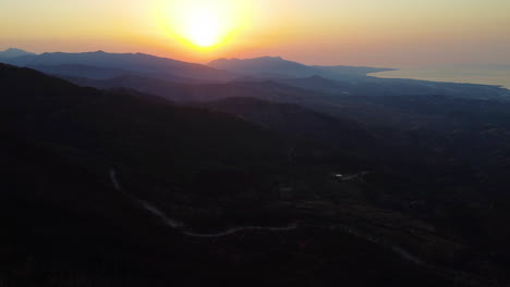 A-drone-flies-through-the-treetops-at-sunset-in-Pico-De-Los-Reales,-Estepona,-Spain