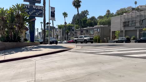 Body-Shop-Strip-Club,-Sunset-Blvd,-West-Hollywood,-Los-Angeles-CA-USA,-Road-Sign-and-Car-Traffic-on-Sunny-Day