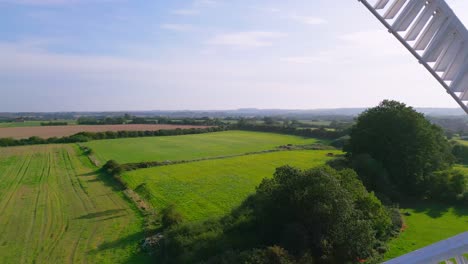Above-the-landscape,-video-footage-reveals-the-historic-Waltham-Windmill-and-Rural-History-Museum-in-Lincolnshire,-UK