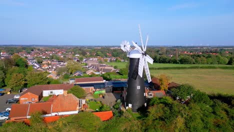 Above-the-landscape,-video-footage-reveals-the-well-known-Waltham-Windmill-and-Rural-History-Museum-in-Lincolnshire,-UK