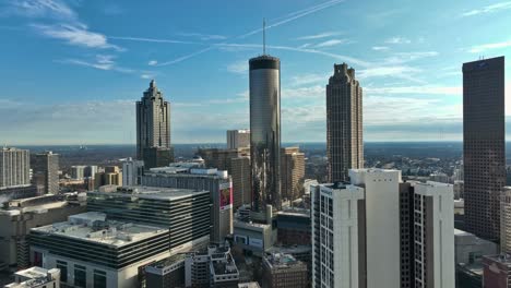 Aerial-approaching-shot-of-Westin-Peachtree-Plaza-Hotel-in-Atlanta-City-during-sunny-day-with-blue-sky