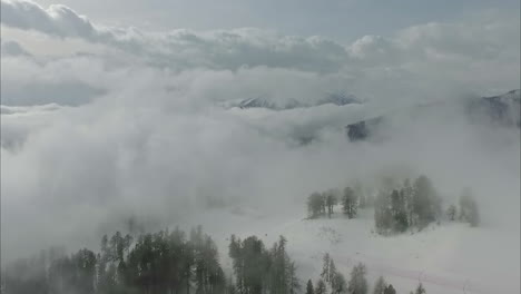 An-Aerial-Shot-Of-A-Clear-White-Snowscape-On-A-Mountain-On-A-Slightly-Cloudy-Weather-In-Austria-Austria