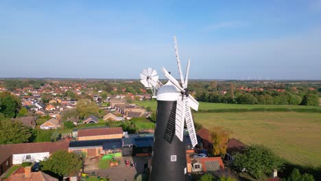 Above-the-countryside,-video-footage-reveals-the-well-preserved-Waltham-Windmill-and-Rural-History-Museum-in-Lincolnshire,-UK