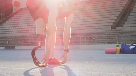 Caucasian-disabled-male-athlete-with-running-blade-stretching-and-training