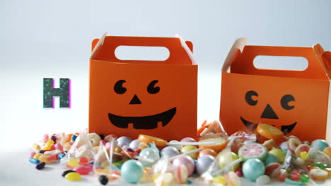 Animation-Von-Halloween-Grüßen-über-Mehreren-Süßigkeiten-Und-Schachteln-Im-Hintergrund