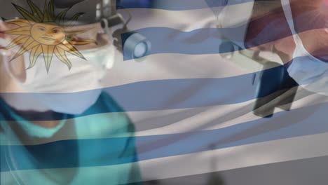 Animation-of-flag-of-uruguay-waving-over-surgeons-in-operating-theatre