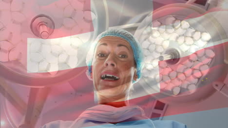 Animation-of-flag-of-switzerland-waving-over-female-surgeon-in-operating-theatre