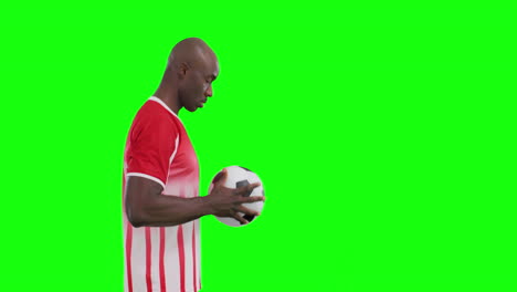 Video-of-african-american-male-soccer-player-with-ball-on-green-screen-background