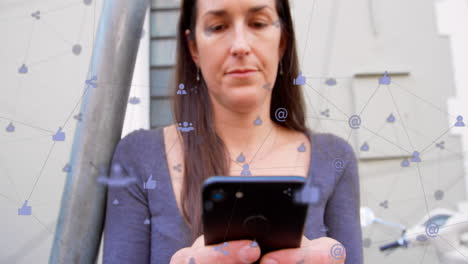 Animation-of-network-of-connections-with-digital-icons-over-caucasian-woman-using-smartphone