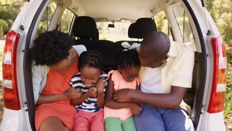 Happy-family-is-sitting-in-the-car-and-smiling-
