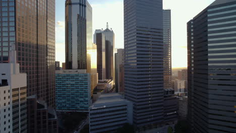 Aerial-view-between-tall-office-buildings,-sunset-in-the-center-of-Dallas,-USA
