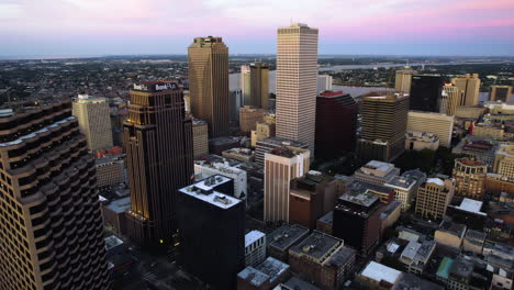 Drone-shot-backwards-over-the-Central-Business-District,-dusk-in-New-Orleans,-USA