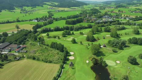 Drone-soars-high,-revealing-an-Austrian-golf-resort-nestled-in-the-picturesque-Mondsee-region,-offering-serene-luxury