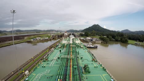 Timelapse-oil-tanker-bow-transit-panama-canal-crossing-Miraflores-locks-tug-boat