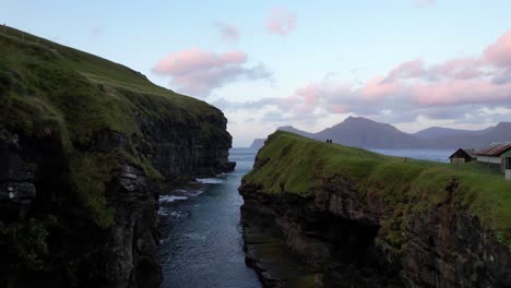 Cinematic-aerial-drone-shot-flying-over-Gjogv-canyon-in-Eysturoy,-Faroe-Islands