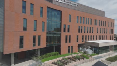 An-aerial-establishing-shot-of-the-UHD-College-of-Sciences-and-Technology,-a-state-of-the-art-facility-designed-by-Kirksey-Architecture,-located-on-White-Oak-Bayou-in-downtown-Houston