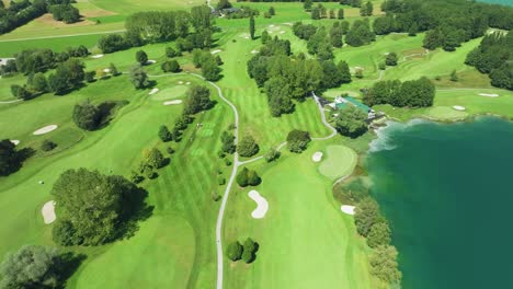 Cinematic-drone:-A-captivating-top-down-view-of-an-Austrian-golf-resort-nestled-beside-the-emerald-waters-of-Mondsee-lake,-offering-serene-luxury