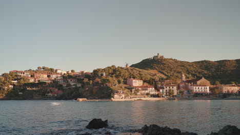 Collioure-coastal-town,-hillside-buildings,-distant-castle-view