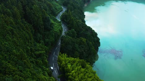Wild-Mountains-of-Shikoku-Japan,-Aerial-View-as-Car-Drives-Through-Forest-Road