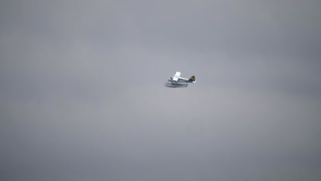 Long-Distance-Shot-of-Beaver-DHC-2-Seaplane-Flying-Against-Grey-Sky