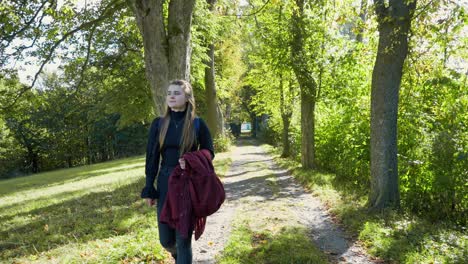 Beautiful-long-haired-female-walking-alone-in-the-countryside