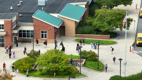 Students-exiting-school-building-after-school-day-at-dismissal-in-USA