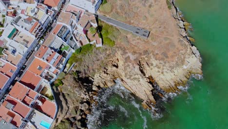 Drone-topshot-from-the-coast-where-cliffs-devide-town-and-sea