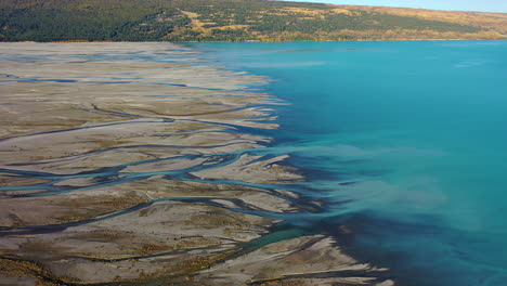 Scenic-aerial-drone-view-over-Lake-Pukaki-and-the-Tasman-River-delta,-New-Zealand