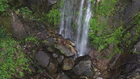 Damp,-lush-mossy-green-base-of-wispy-waterfall-in-Honduras-jungle
