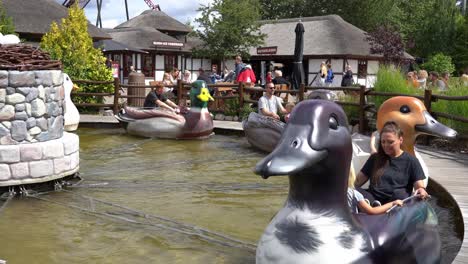Children-and-families-having-fun-riding-duck-carousel-in-Djurs-amusement-park-in-Denmark