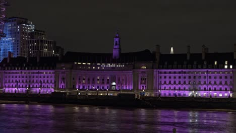 County-Hall-illuminated-at-night-along-River-Thames,-London