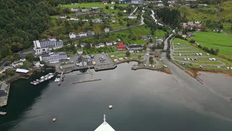 Aerial-of-a-cruise-ship-from-the-AIDA-line-moored-of-the-village-of-Gieranger-at-the-head-of-the-Geirangerfjord,-Norway