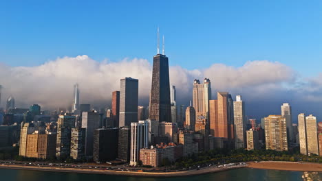 Drone-shot-orbiting-the-John-Hancock-Center,-golden-hour-in-Streeterville,-Chicago