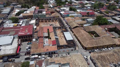 Aerial:-Roof-tops-and-street-traffic-in-small-town-Gracias,-Honduras
