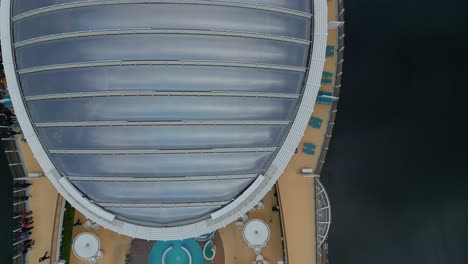 Overhead-aerial-of-a-cruise-ship-from-the-AIDA-line-moored-of-the-village-of-Gieranger-at-the-head-of-the-Geirangerfjord,-Norway