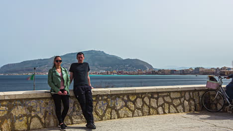 Time-lapse-on-the-medieval-city-fortress-Torre-di-Ligny-in-the-city-of-trapani-in-italy-with-view-of-a-couple-taking-selfies-of-their-trip,-the-sea-and-the-beautiful-landscape-on-a-sunny-day